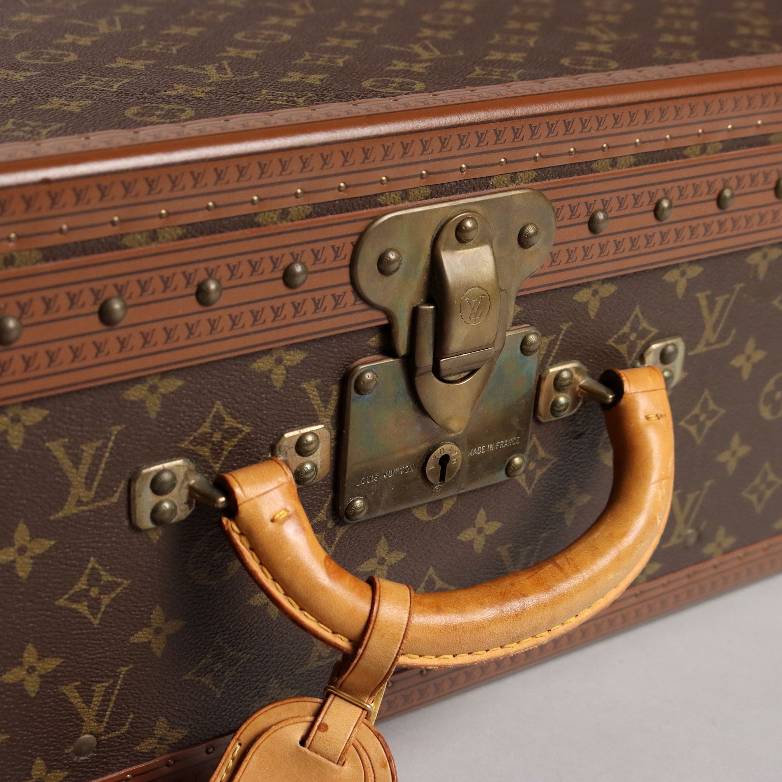 Lot - A Louis Vuitton monogram canvas hard sided Alzer 80 suitcase, mid  20th century